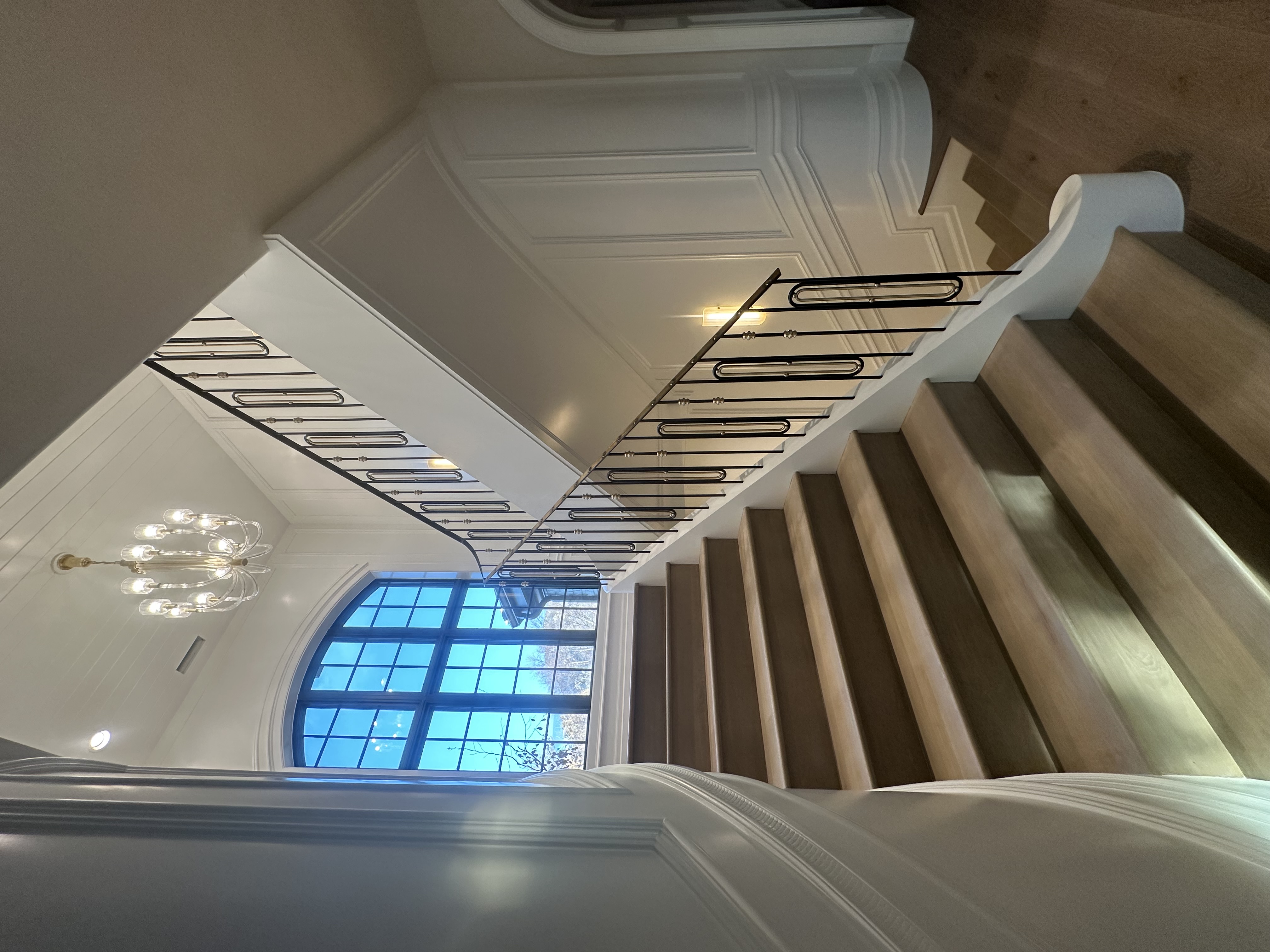 Custom wrought iron curved staircase railing — luxury Utah home